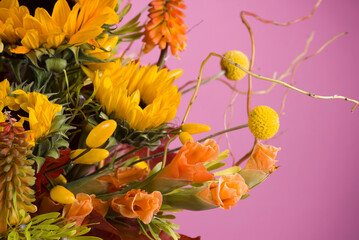Sunflowers and bright flowers on the yellow background