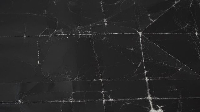 Wrinkled black old paper with frayed wrinkles and a contrasting texture. Dusty cardboard wrapping. Abstract dramatic background
