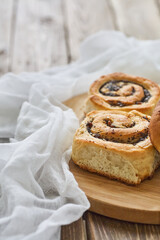 Tasty buns with raisins on a brown rustic wooden table. fresh bakery. breakfast. bread. top view