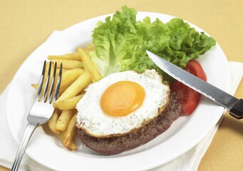 Steak with Egg, French Fries and Salad on Plate