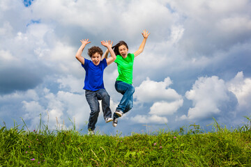 Girl and boy running, jumping outdoor