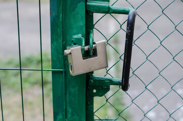 Metal padlock on the gate.