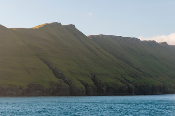 Golden hour shedding light on the isle of Hestur.