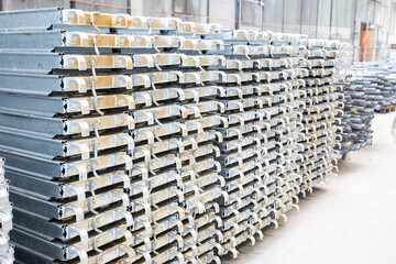 warehouse of metal products. part of the flooring for construction of the rafters stacked in the same stack