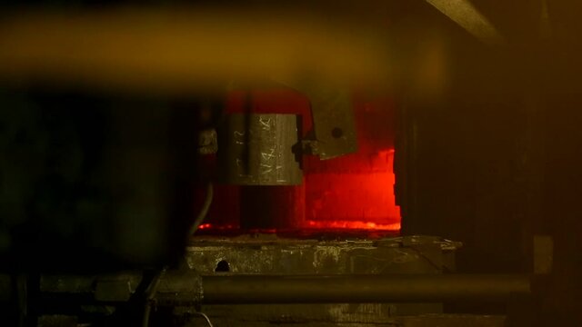 Steel press rolling industrial workshop. Hot iron stamping of train and wagon wheels. Industrial details of metallurgic factory or plant.