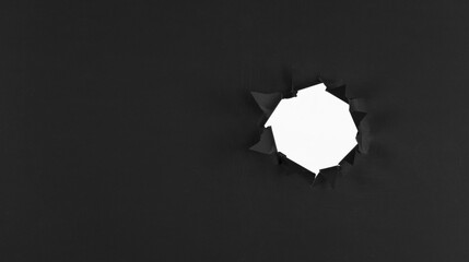black abstract paper background with black torn hole