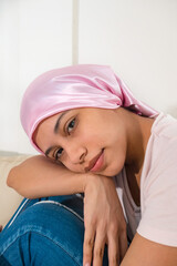 A young woman with a pink headscarf. Concept of breast cancer