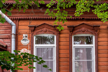 Fototapeta na wymiar old wooden windows with beautiful carved platbands