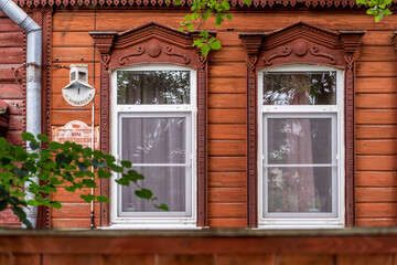 Fototapeta na wymiar old wooden windows with beautiful carved platbands