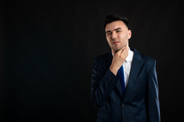 Portrait of business man wearing blue business suit and tie gesturing neck ache