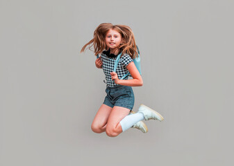 Full length photo of little pupil jump high finally holidays wear isolated on gray background