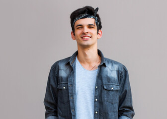 Closeup of happy smiling guy looking at camera isolated on gray background