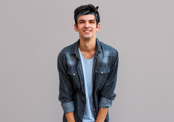 Closeup of happy smiling guy looking at camera isolated on gray background