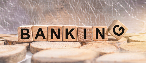 Banking word concept written on wooden cubes on wooden table. Banking saving financial investment concept.