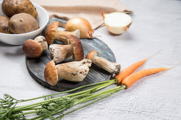 White forest mushrooms on a light background. Cooking organic mushrooms. The summer harvest. Horizontal position