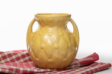 Antique yellow ceramic vase isolated on a white background
