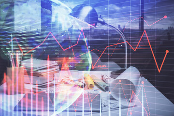 Double exposure of stock market graph drawing and office interior background. Concept of financial analysis.