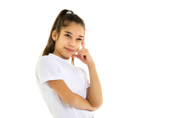 Fototapeta premium Emotional little girl in a clean white T-shirt.