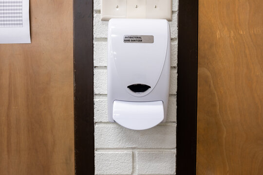 Hand Sanitizer Station Mounted By Door In School Classroom Or Office