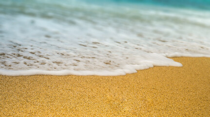 clear ocean water waves on beach sand.