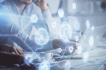 Double exposure of man and woman working together and technology theme drawing hologram. Big data concept. Computer background.