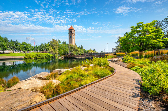 Summer day along the Spokane River in Riverfront Park with the Clock Tower, Pavilion and walking path in view.