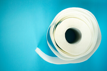 Advertise banner with toilet paper and copy space. Paper towel roll on blue background. Hygiene stuff for everyday and body care products. 