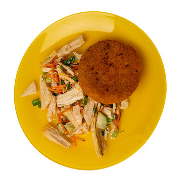 fishcake with soy asparagus and carrots, cucumbers and dilll. fish cutlet on a plate isolated. cutlet with vegetables top view