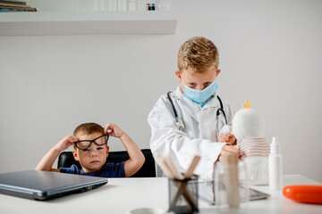 Two boys are playing doctor,