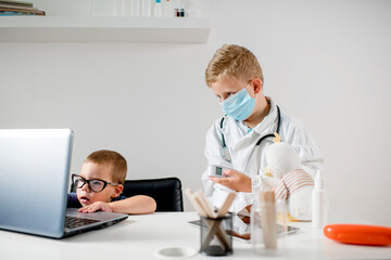 Two boys are playing doctor,