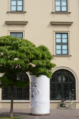 beautiful tenement houses in the city center, with a tree and a bicycle leaning against the wall