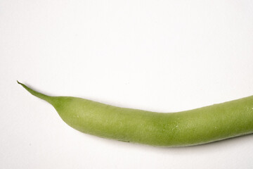 Single green bean freshly picked from the garden isolated on a white background
