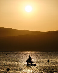 Fototapeta premium silhouette of a family in the sea during the sunset in Cabo de Gata, Almeria