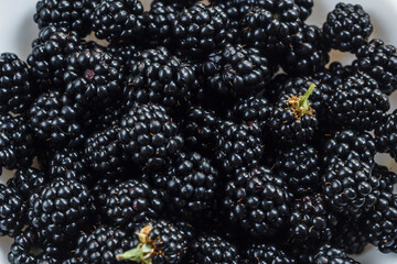 Fresh ripe blackberries close-up. Blackberry texture. Healthy summer berries. Healthy vegetarian food. Background from large berries of blackberries.