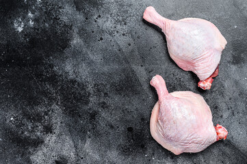 Free range raw Duck legs.  Black background. Top view. Copy space