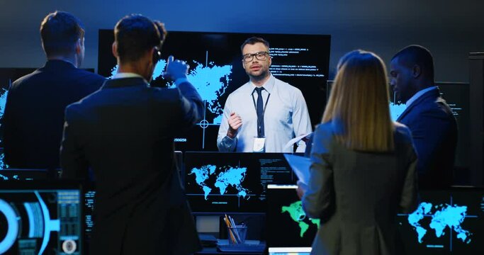 Caucasian man speaker analytic of military security explaining geolocation facilities to mixed-races council of colleagues. Multiethnic government deciding important issues of dislocation.