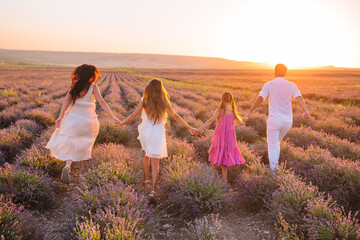 Family of four in lavender flowers field
