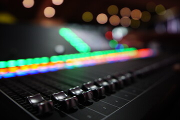 Black audio sound mixer with sliders button. Bokeh background