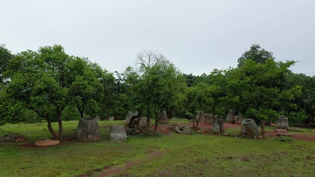 The remains of the Plain of Jars on top of a hill in Asia, Laos, towards Luang Prabang, in summer, on a cloudy day.