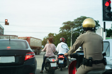 Police man riding on the motorcycle waiting for a traffic signal