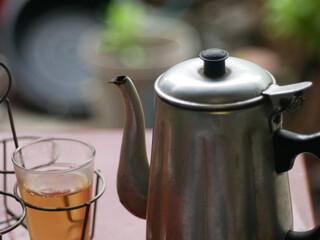 Kettle with hot tea glass on blurred background. local thai food and drink.