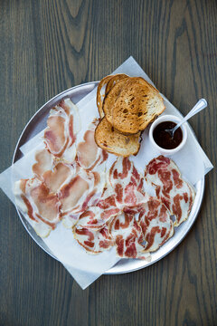 Plate of prosciutto and bread.