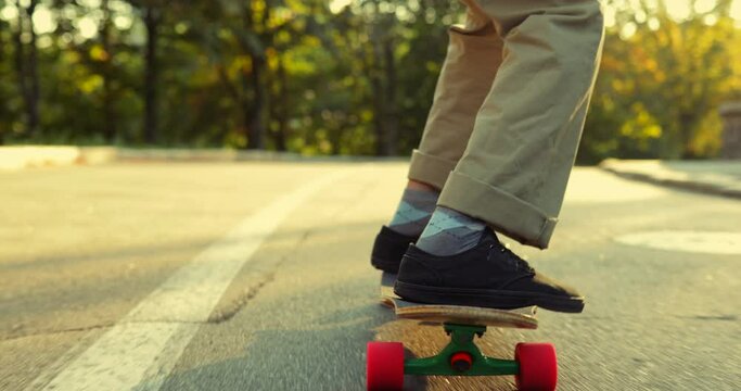 Man performs a trick on a skateboard, longboard. View from below.