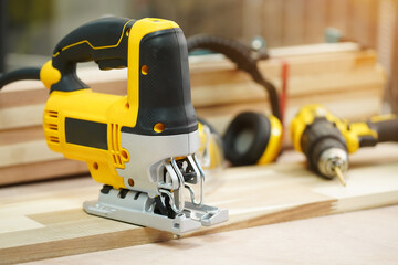 Power tool .Electric jig saw machine on Walnut Plywood in workshop, woodworking Handicraft and diy...