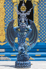 Chiangrai, Thailand - June 7, 2020: Blue Garuda on Wat Rong Suea Ten Church Background with Natural Light in Portrait View at Chiangrai Thailand