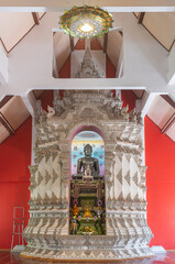 Phayao, Thailand - Dec 8, 2019: Black Buddha Statue in White Pagoda or Stupa with Natural Light in Portrait View