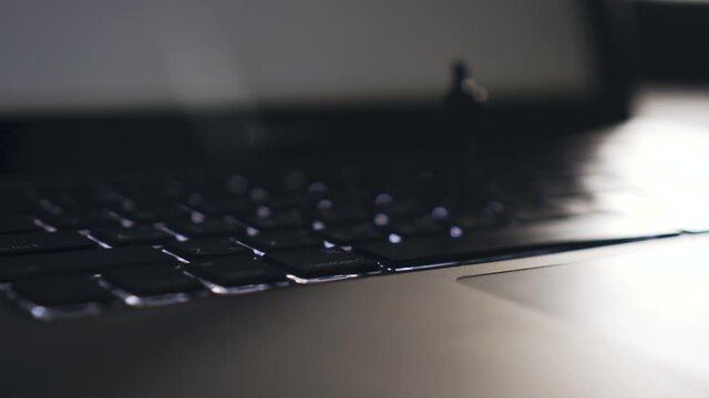4K Video Close up zoom out shot mini businessman standing on notebook keyboard. Background for computer and technology.