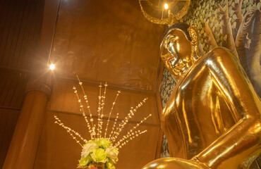 Phayao, Thailand - Dec 31, 2019: Gold Buddha Statue with Warm Light in Wat Yuan or Yuan Temple in Chiang Kham District Phayao Thailand on Side View