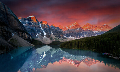 Dramatic sunrise during first break of dawn at Moraine Lake in the Canadian Rockies of Banff...
