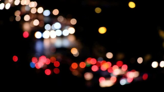 blurred movie video of background bokeh car lights city night